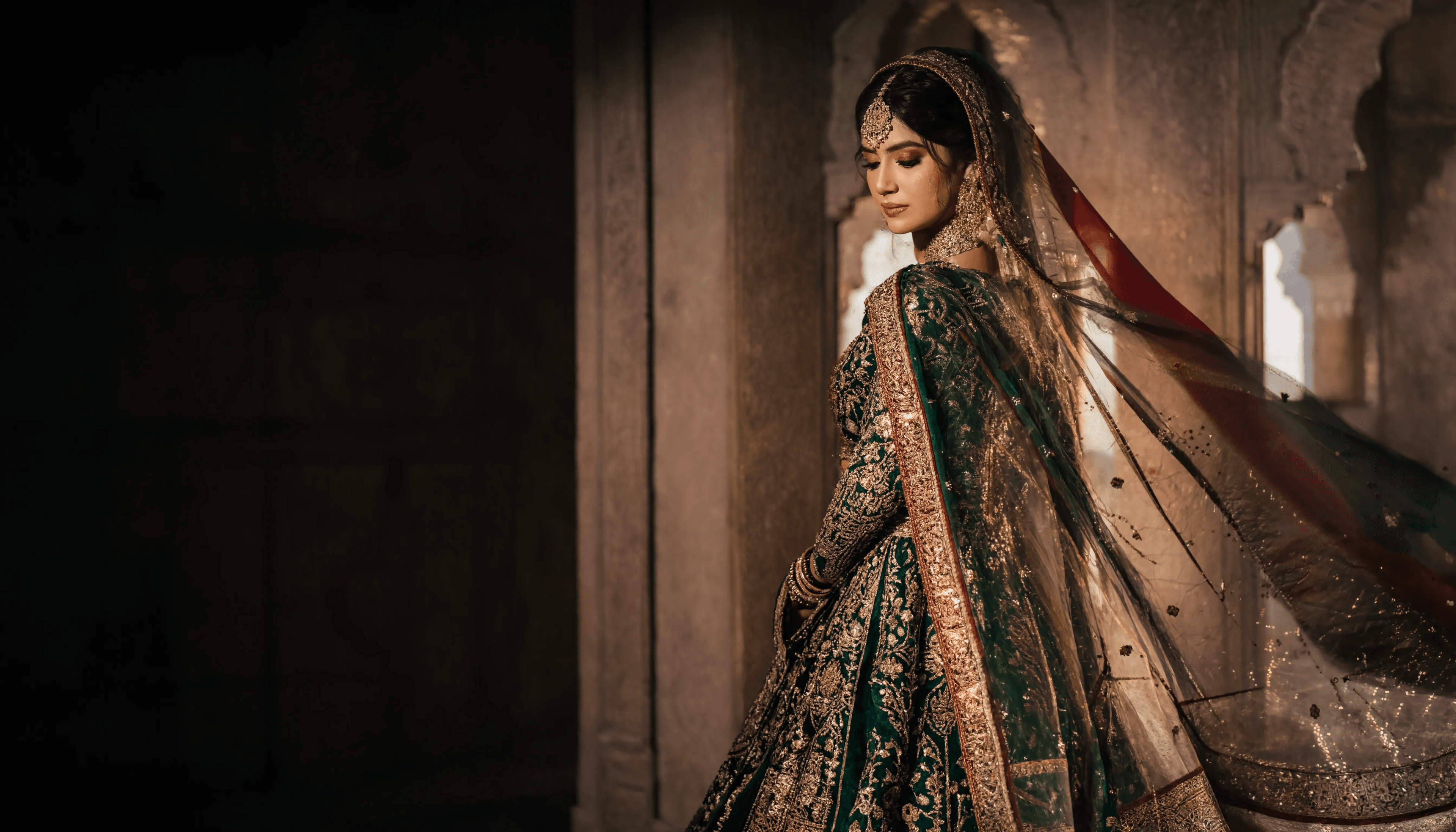 Pakistani bride in emerald and gold handcrafted bridal couture